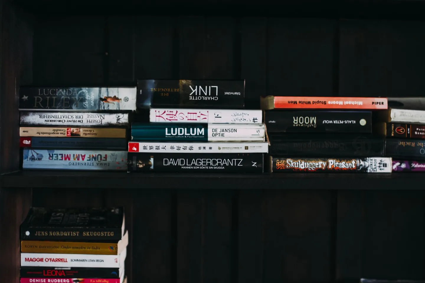 Стопка книг на тёмном деревянном столе
